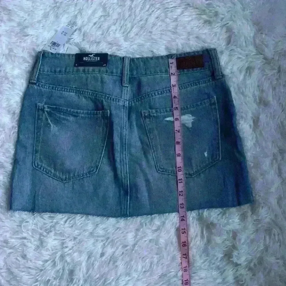 Hollister Denim Mini Skirt.  Size 9/waist 29.  Distressed w frayed edging. NWT.